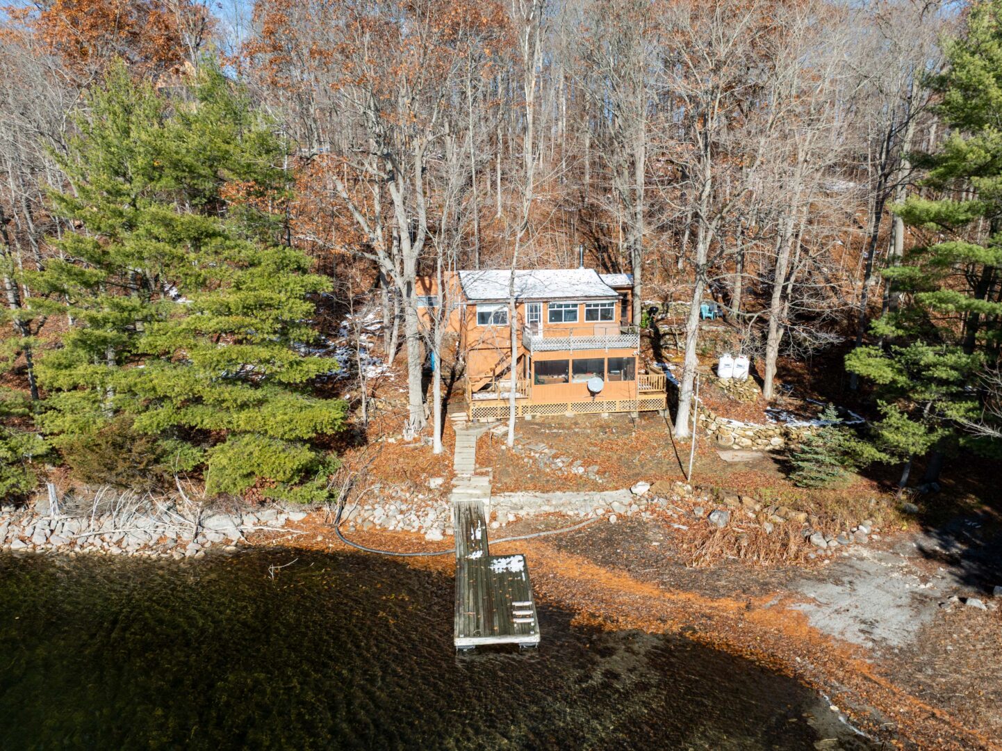 An orange-toned wood cabin on lakeside property