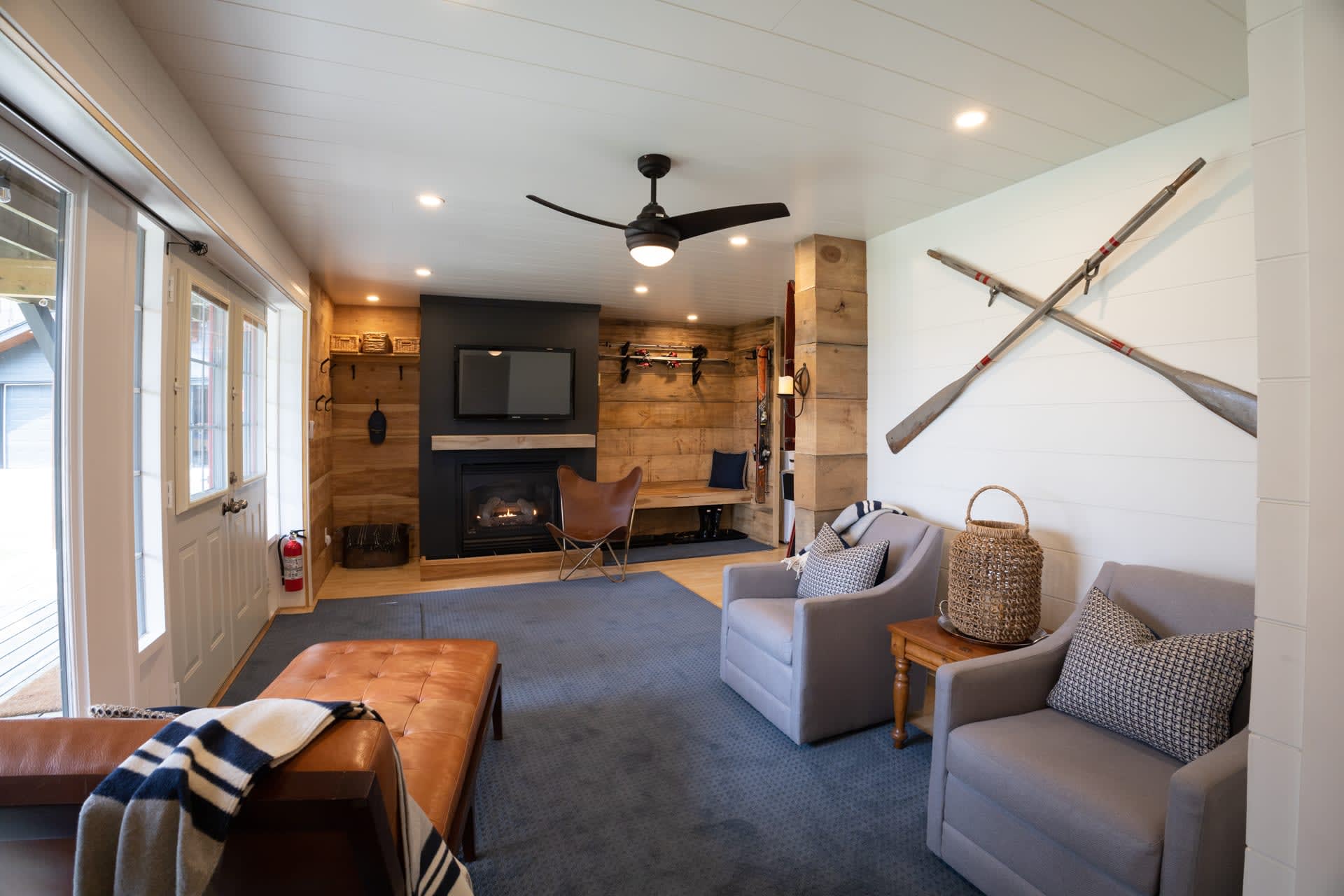 Grey couches in a living area with a grey carpet and a fireplace