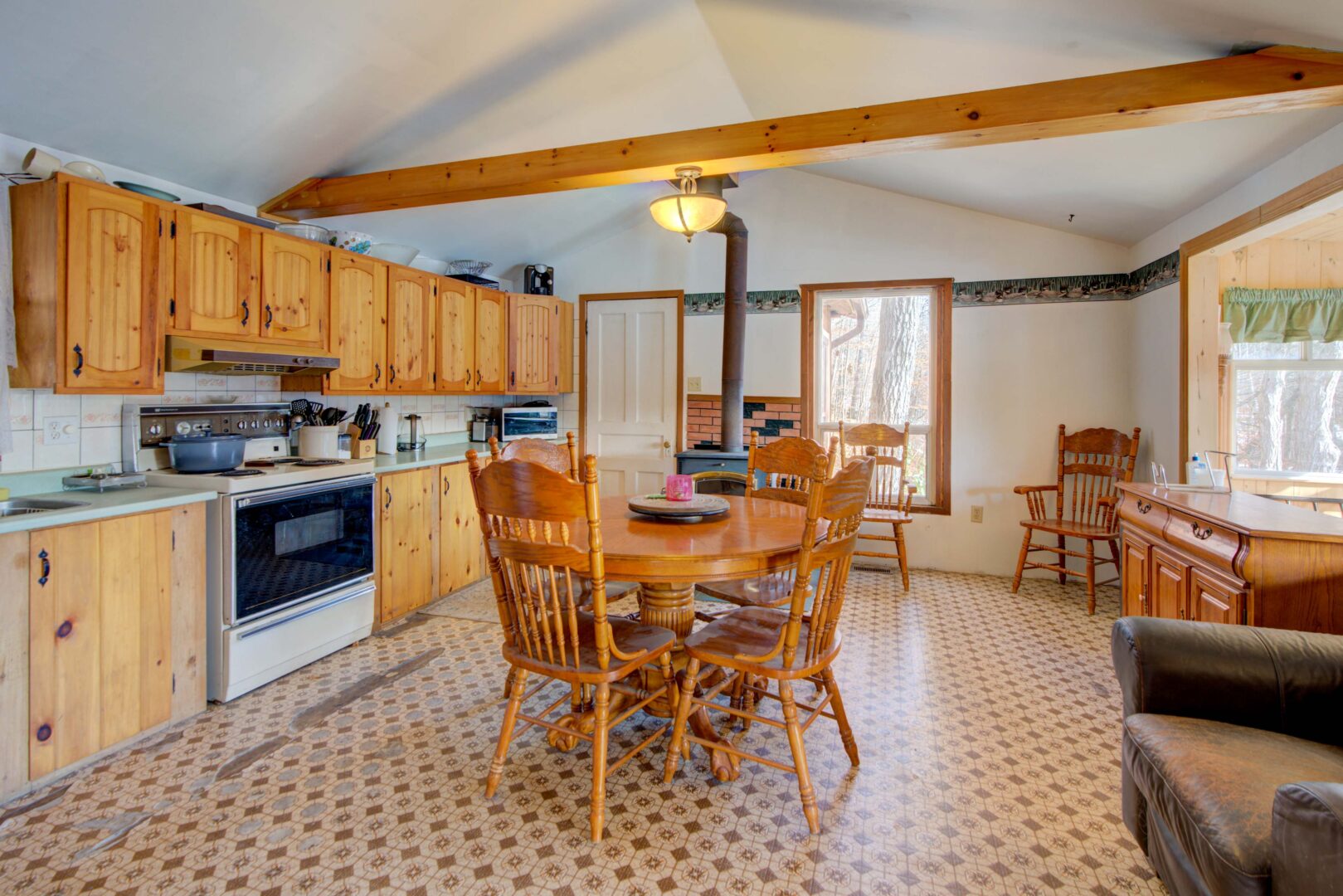 A small wood table in a wood and white kitchen
