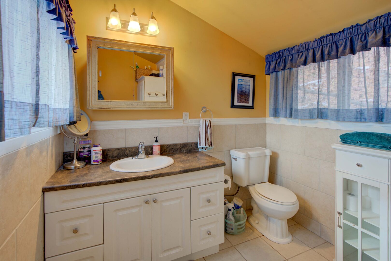A light orange bathroom with a white vanity