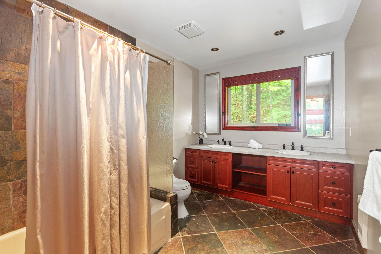 A bathroom with checkered floors and a wood vanity