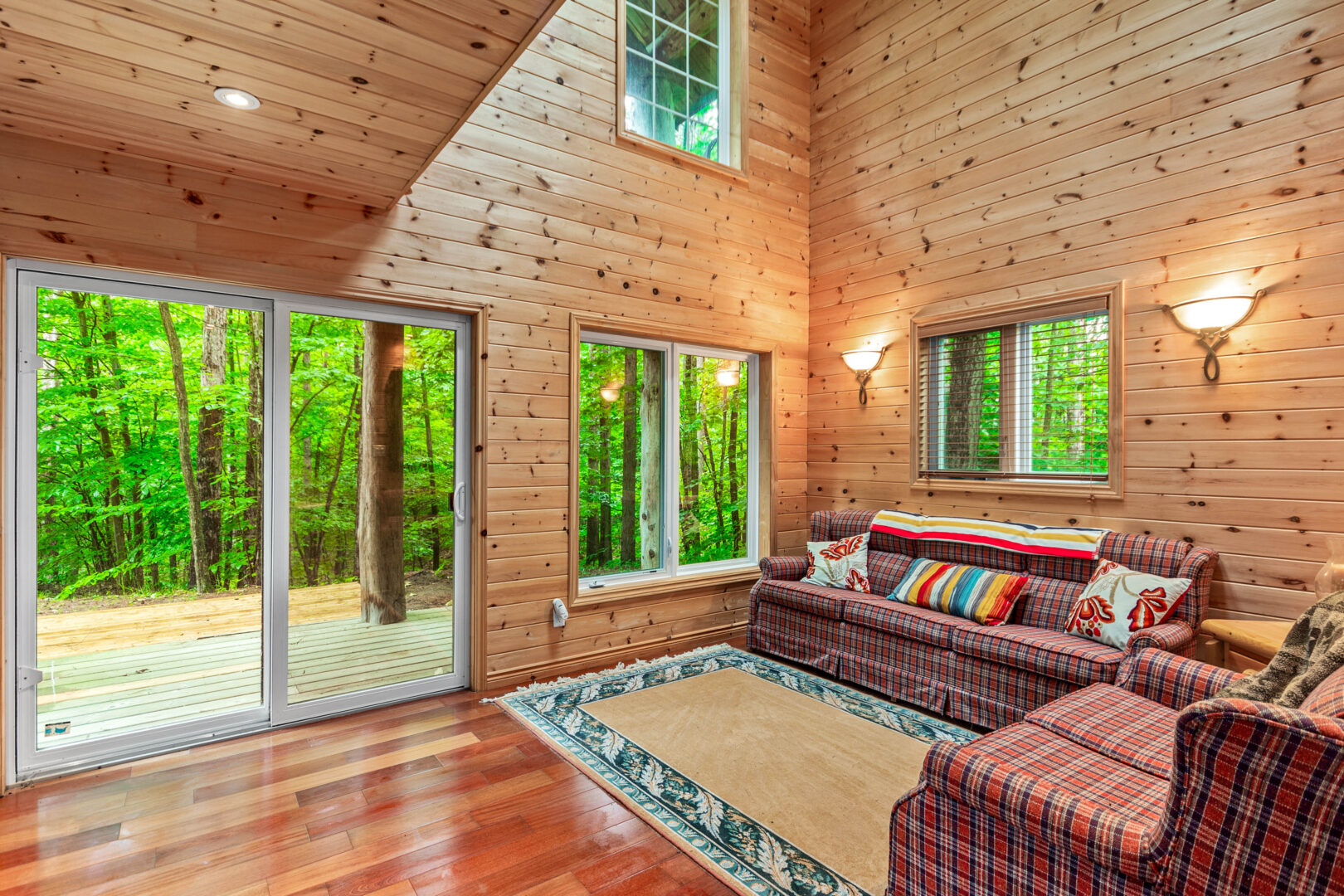 A cozy living room in a wood paneled cabin