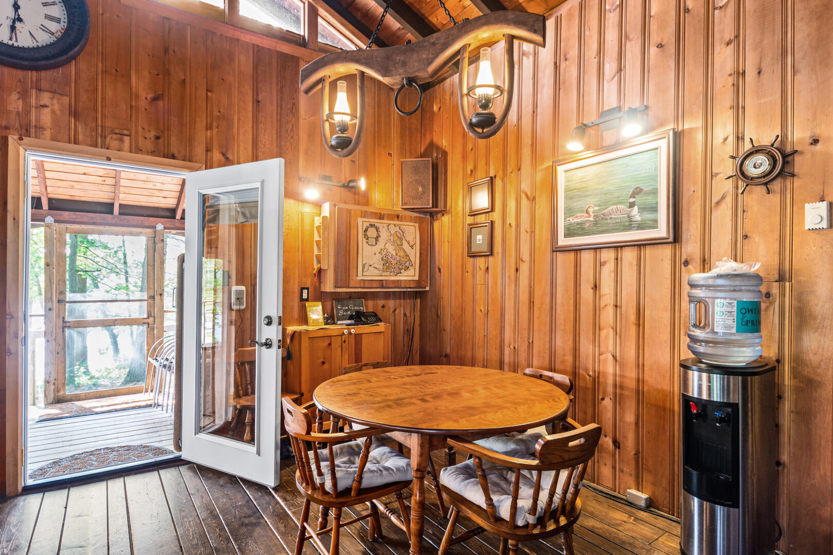 A small round wood table in a wood paneled room