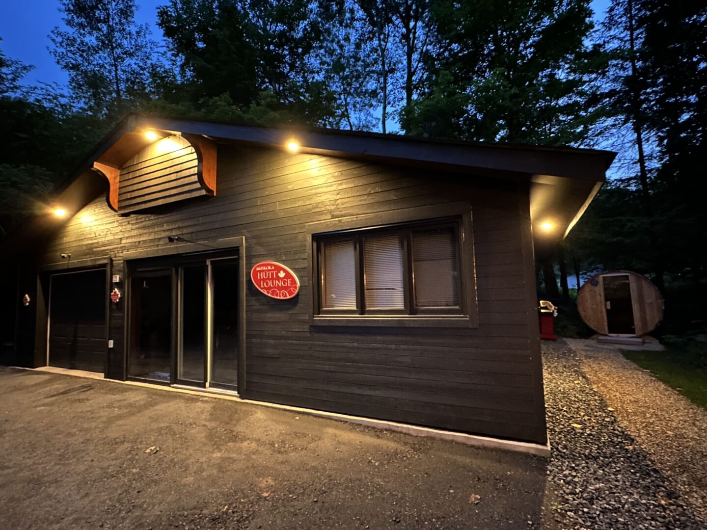 A dark grey paneled building at night