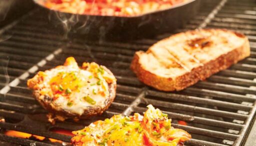 grilled portobello mushrooms with egg and smoked trout on a grill