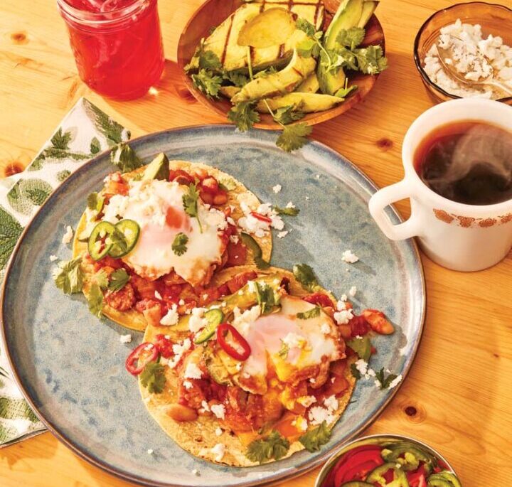 Huevos Rancheros with Sausage and Grilled Avocado on a table