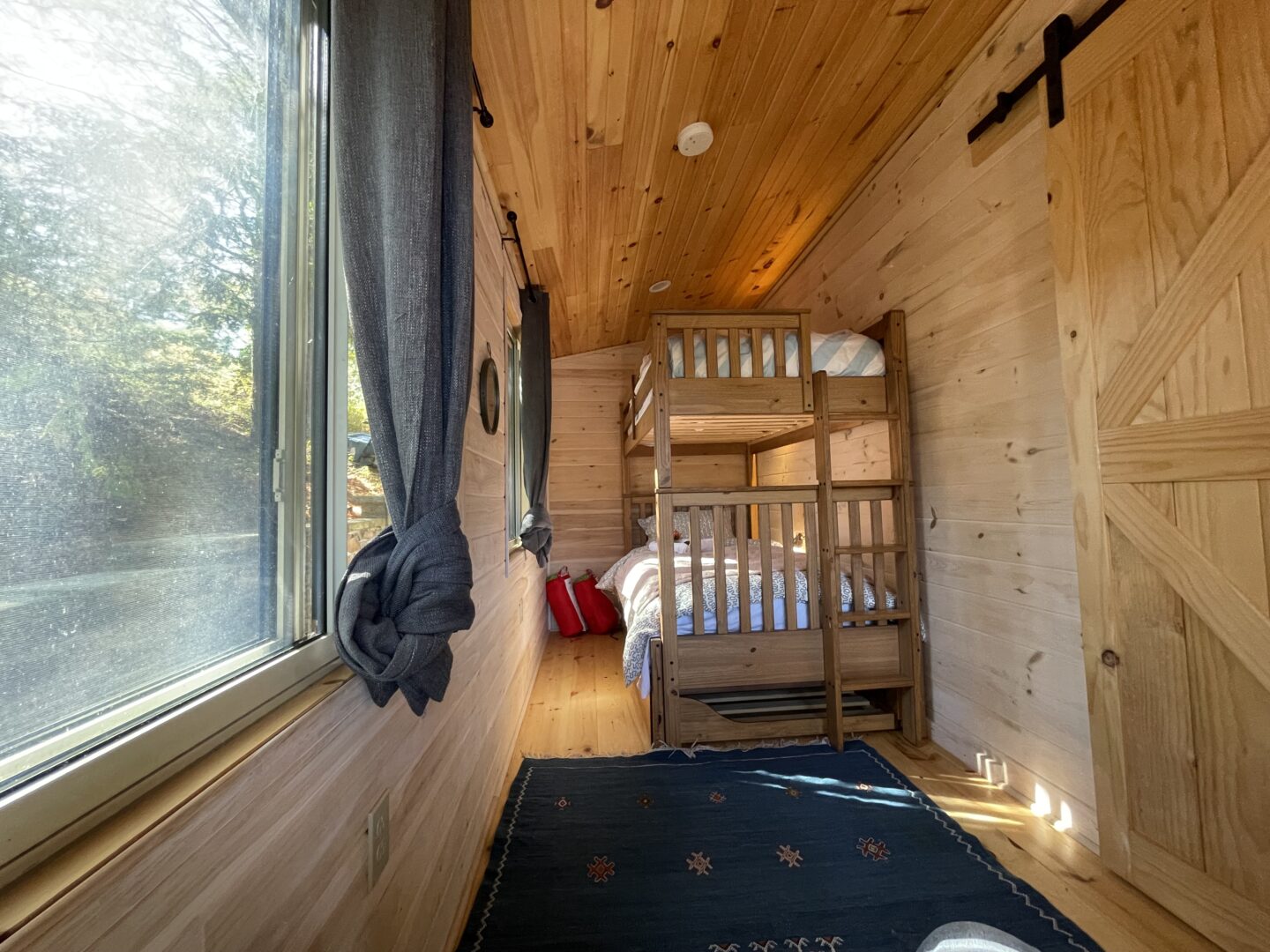 Wood bunk beds in a wood paneled room