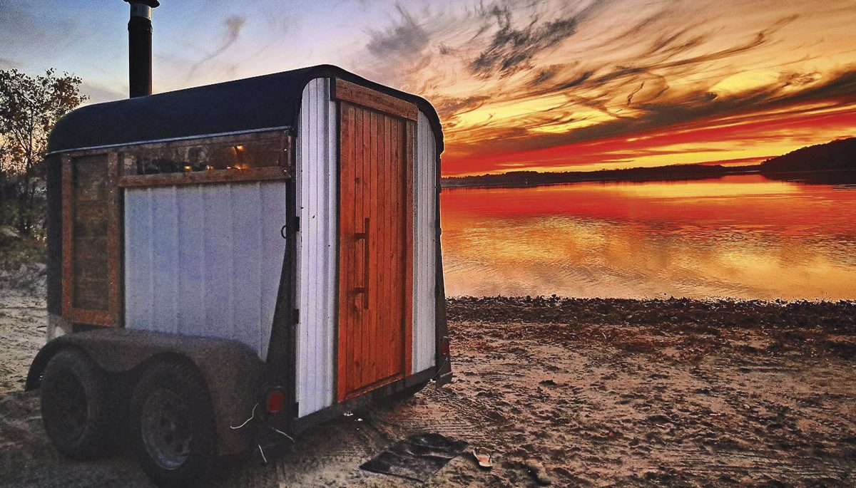 One of the horse trailer saunas on the beach at sunset
