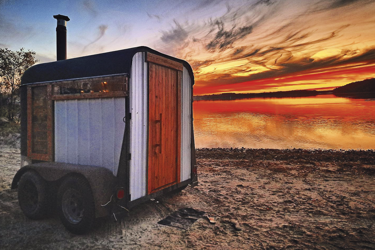 One of the horse trailer saunas on the beach at sunset