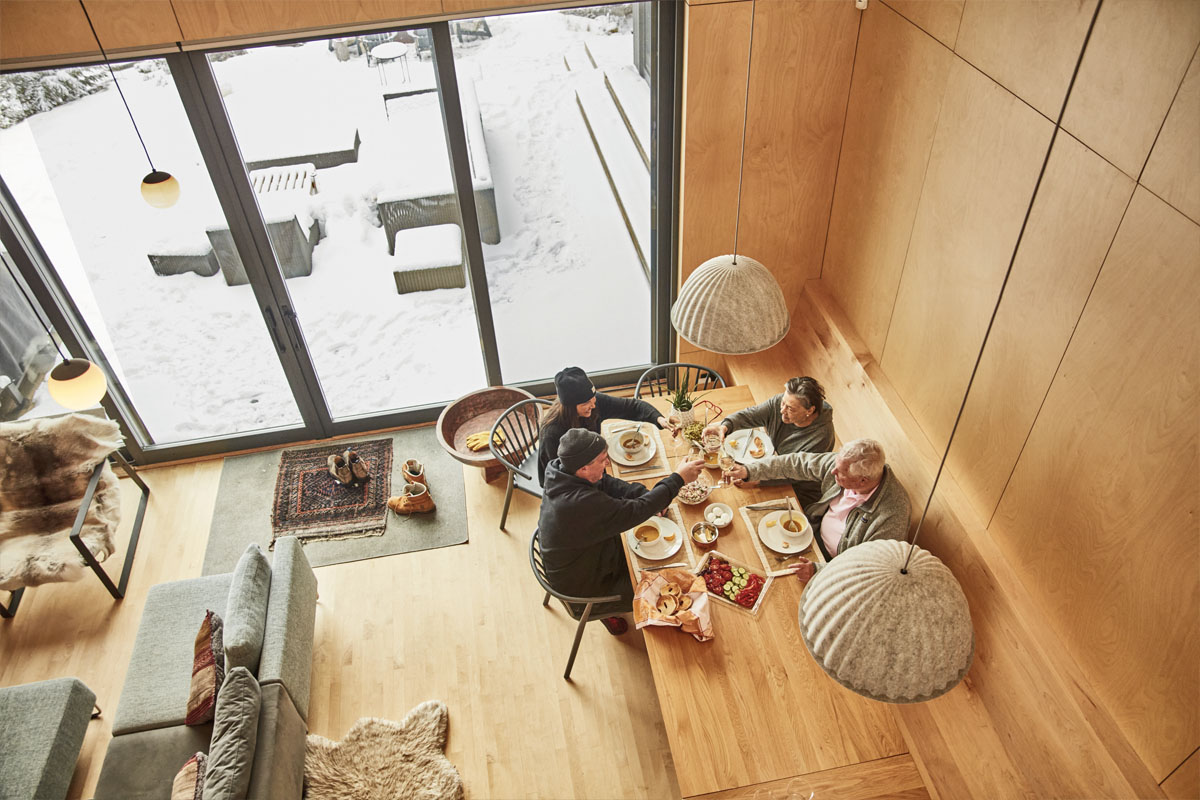 A top down shot from the loft of the family eating at the dining room table