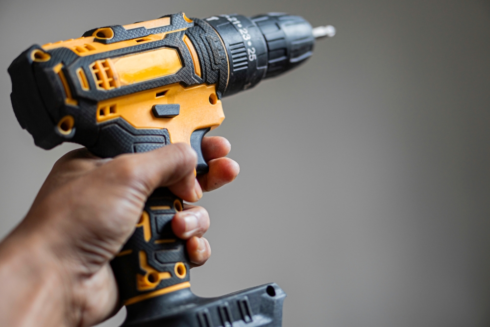 Close-up of a hand holding a cordless drill