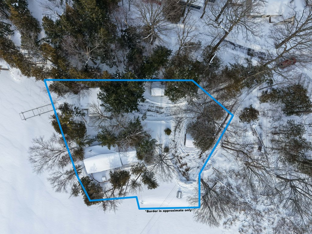 Drone image showing the outlined property boundaries of the cottage lot in winter.