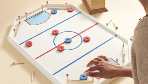 Someone playing the tabletop crockey rink game