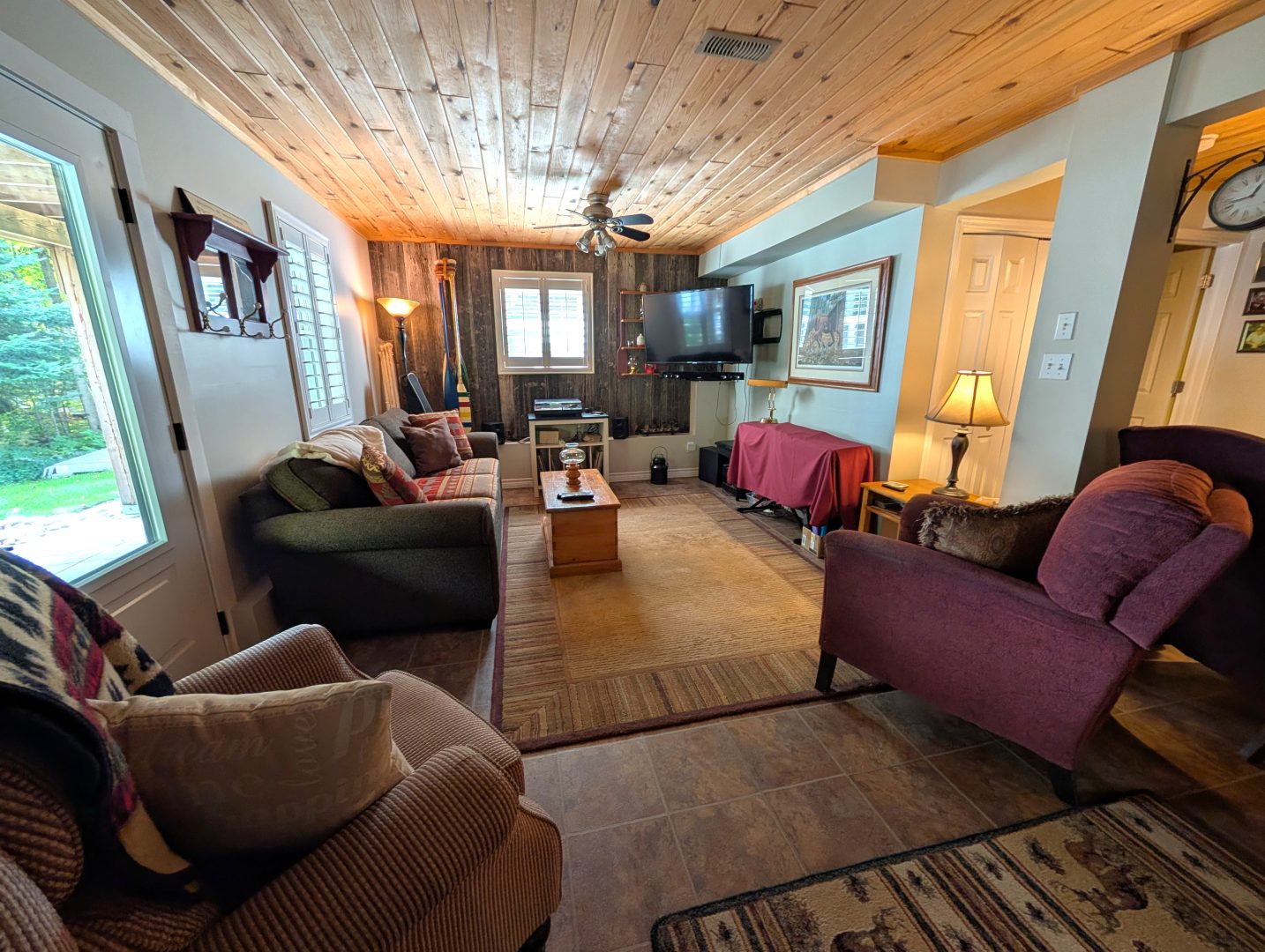Plush chairs face each other in a basement living area