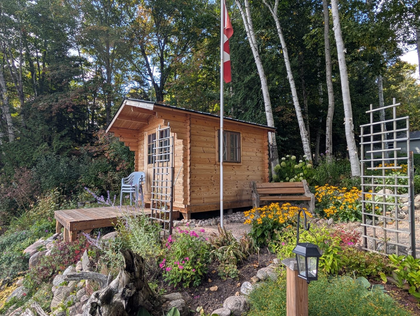 A small wood bunkie next to a Canada flag pole