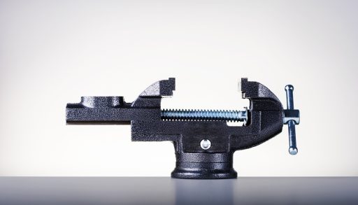 A black vise on a worktable