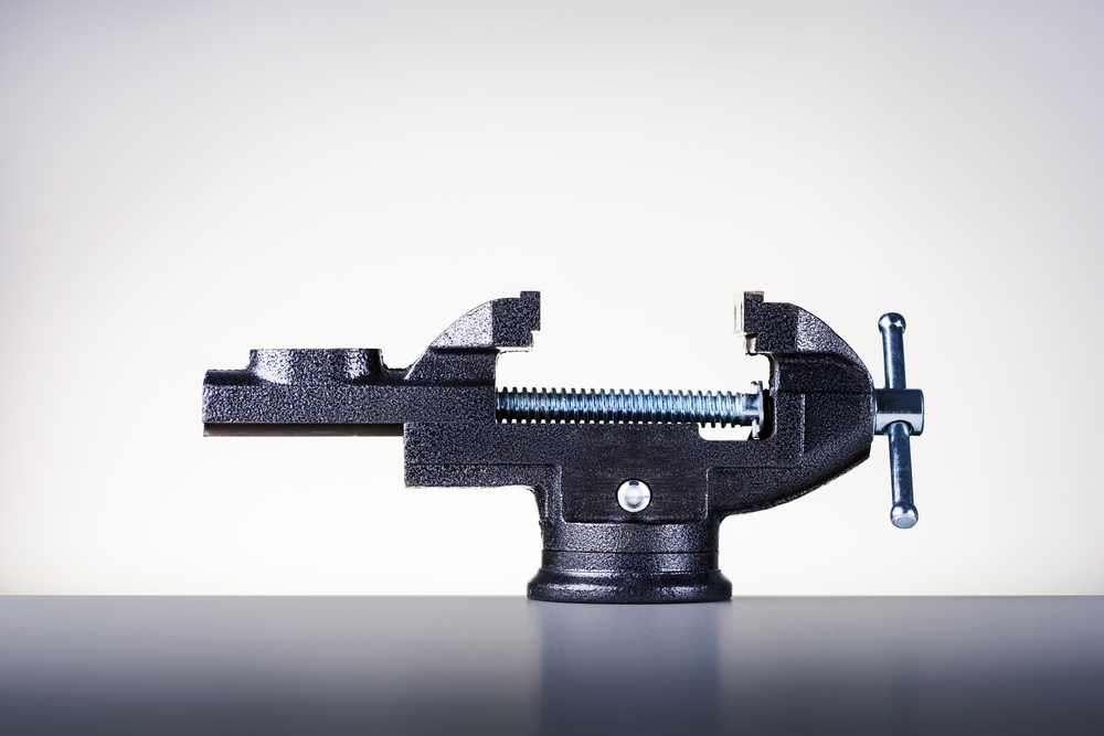 A black vise on a worktable