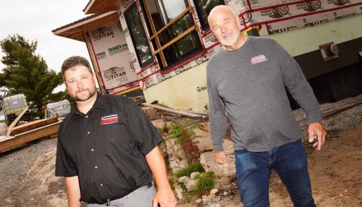 Armin Grigaitis and his business partner, Kyle Scobie (opposite, right and left) walking in front of a construction project for Georgian Bay cottagers.