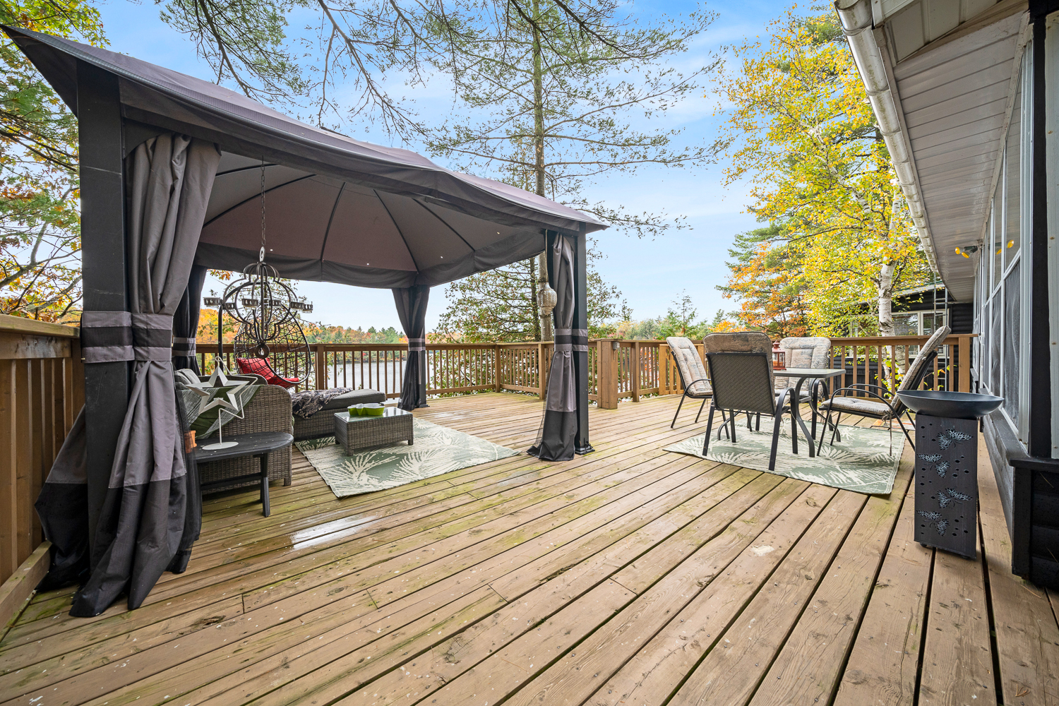 A sitting area under a gazebo on a deck