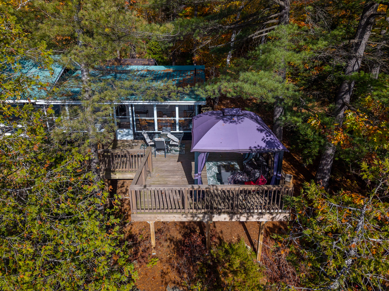 Aerial view of a deck with a purple-covered gazebo