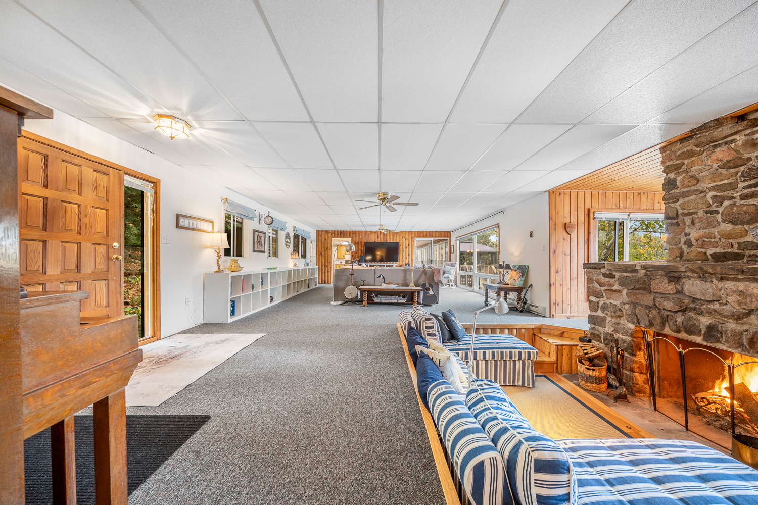 The conversation pit is in frame, while the living room is tucked away across the empty carpeted room