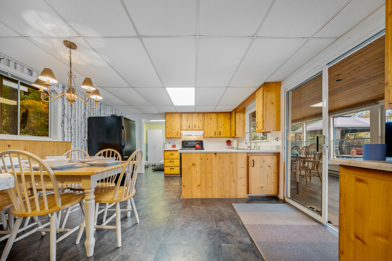 A light wood kitchen with grey tiled floors and a small breakfast nook