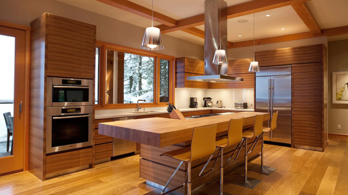 Kitchen of the alpine chalet featuring wooden cabinets and a wooden island.