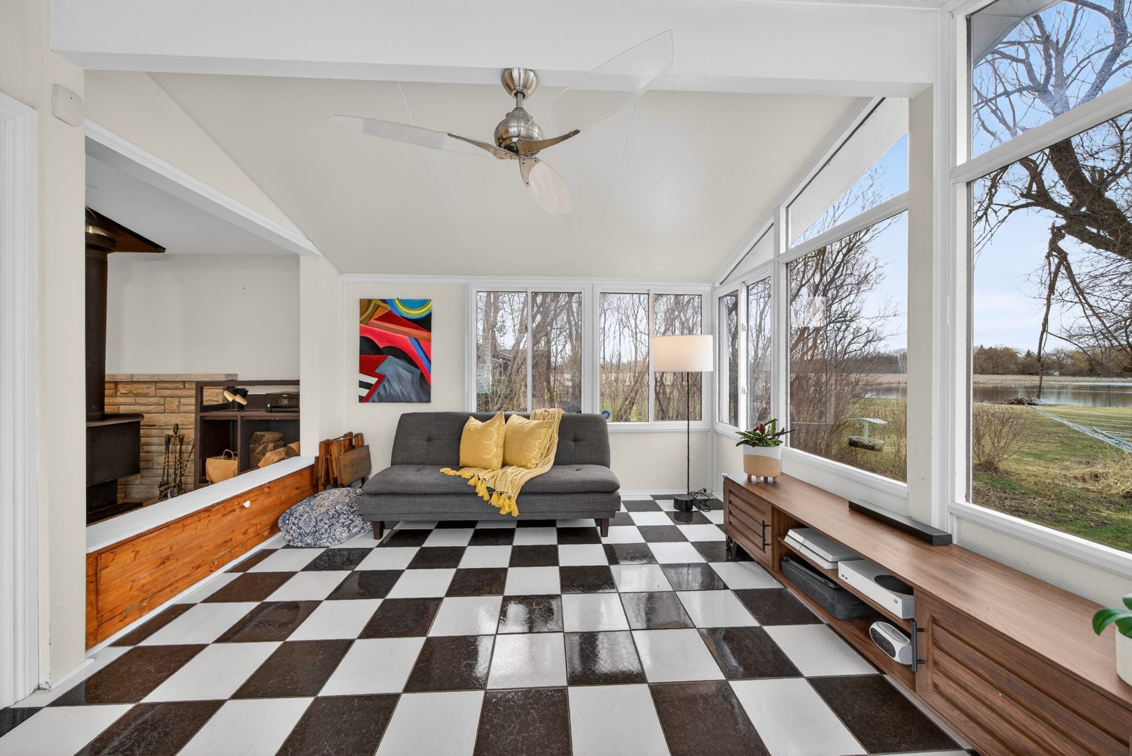 A white sun room with black-and-white checkered flooring and windows