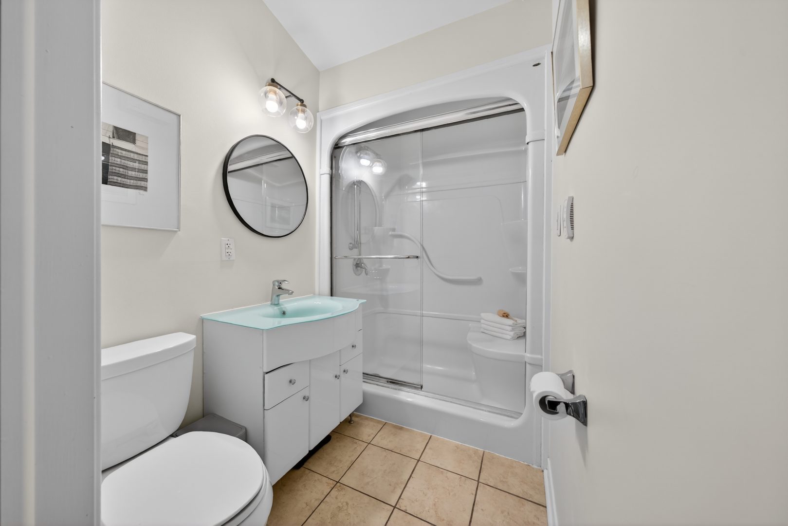 A white bathroom with a walk-in shower