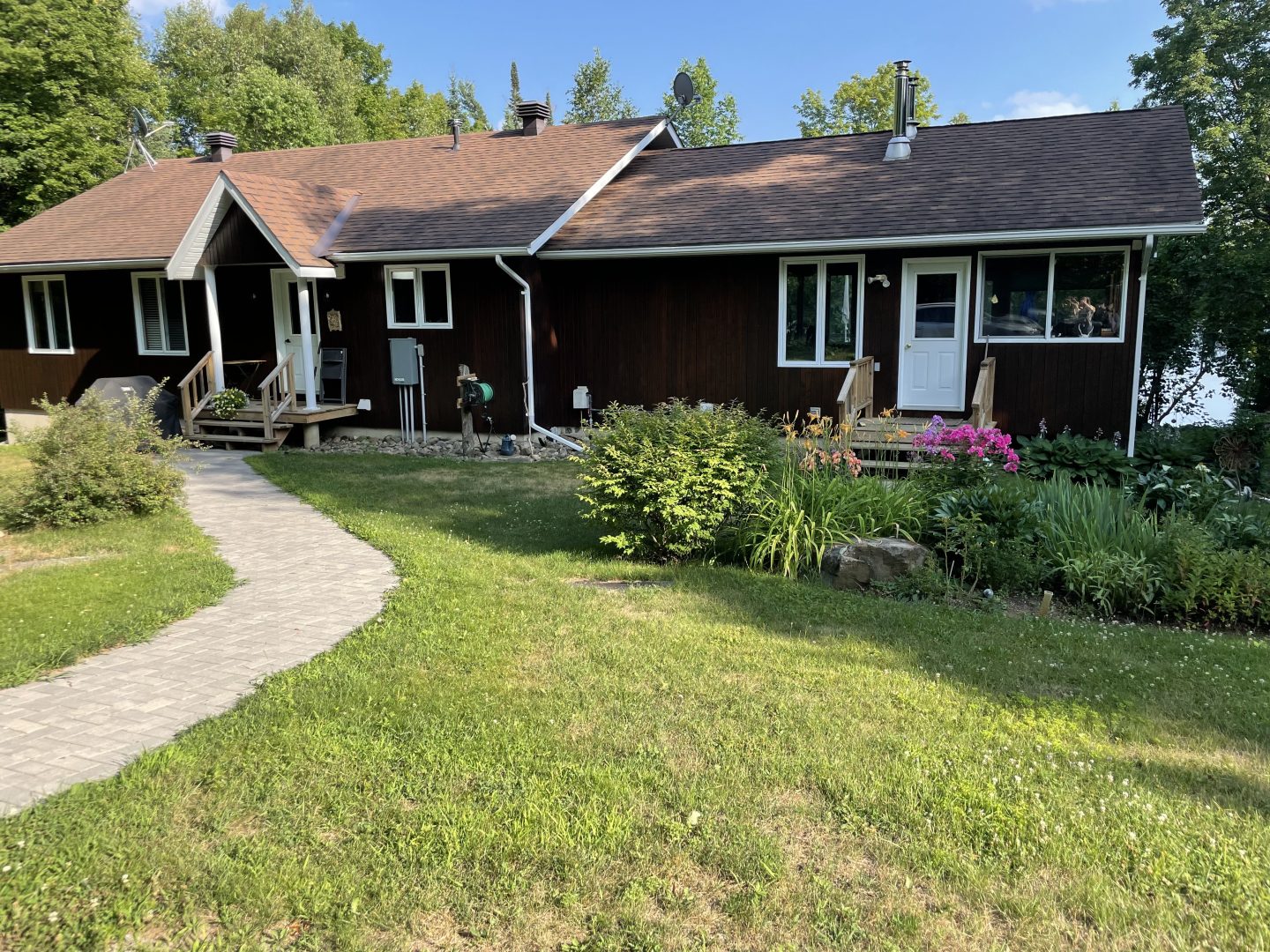 An oversized bungalow on a grassy lawn with florals