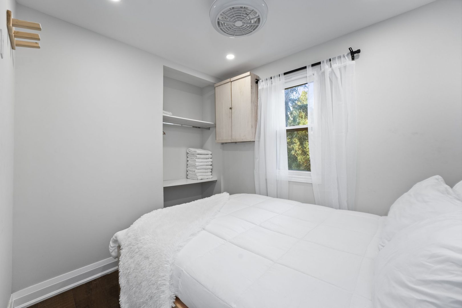 A white bed in a white bedroom