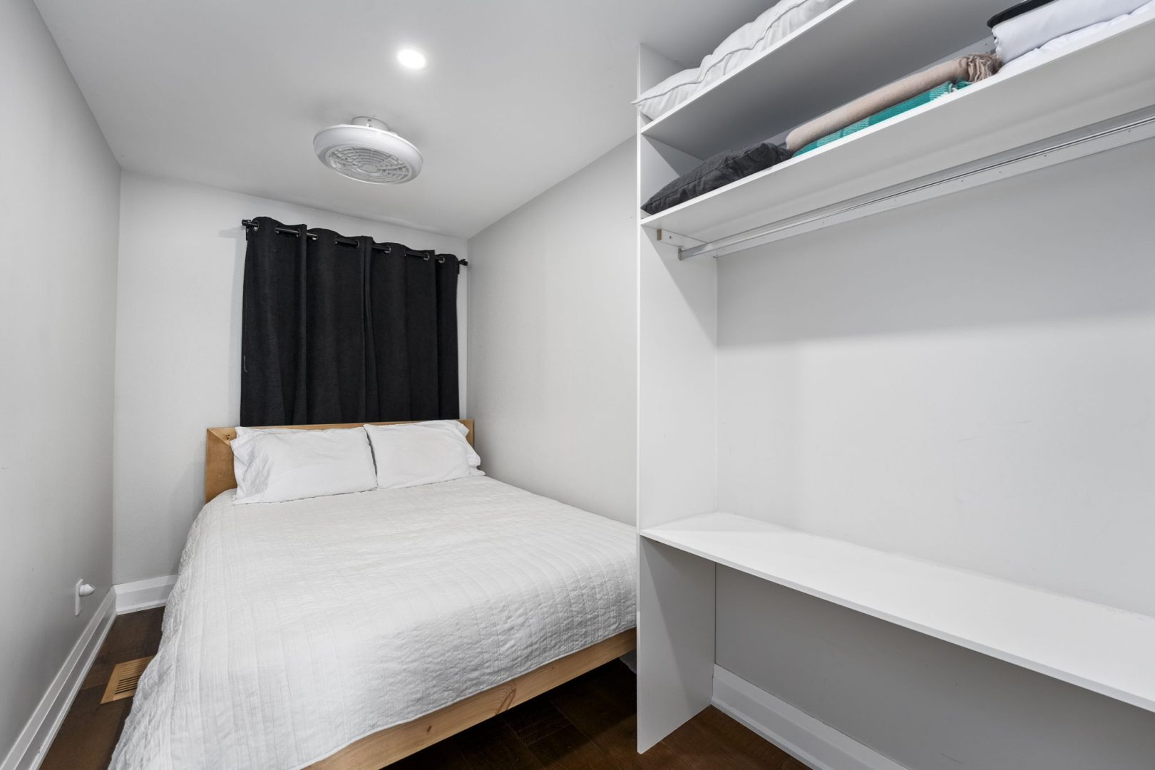 A white bed in a white bedroom
