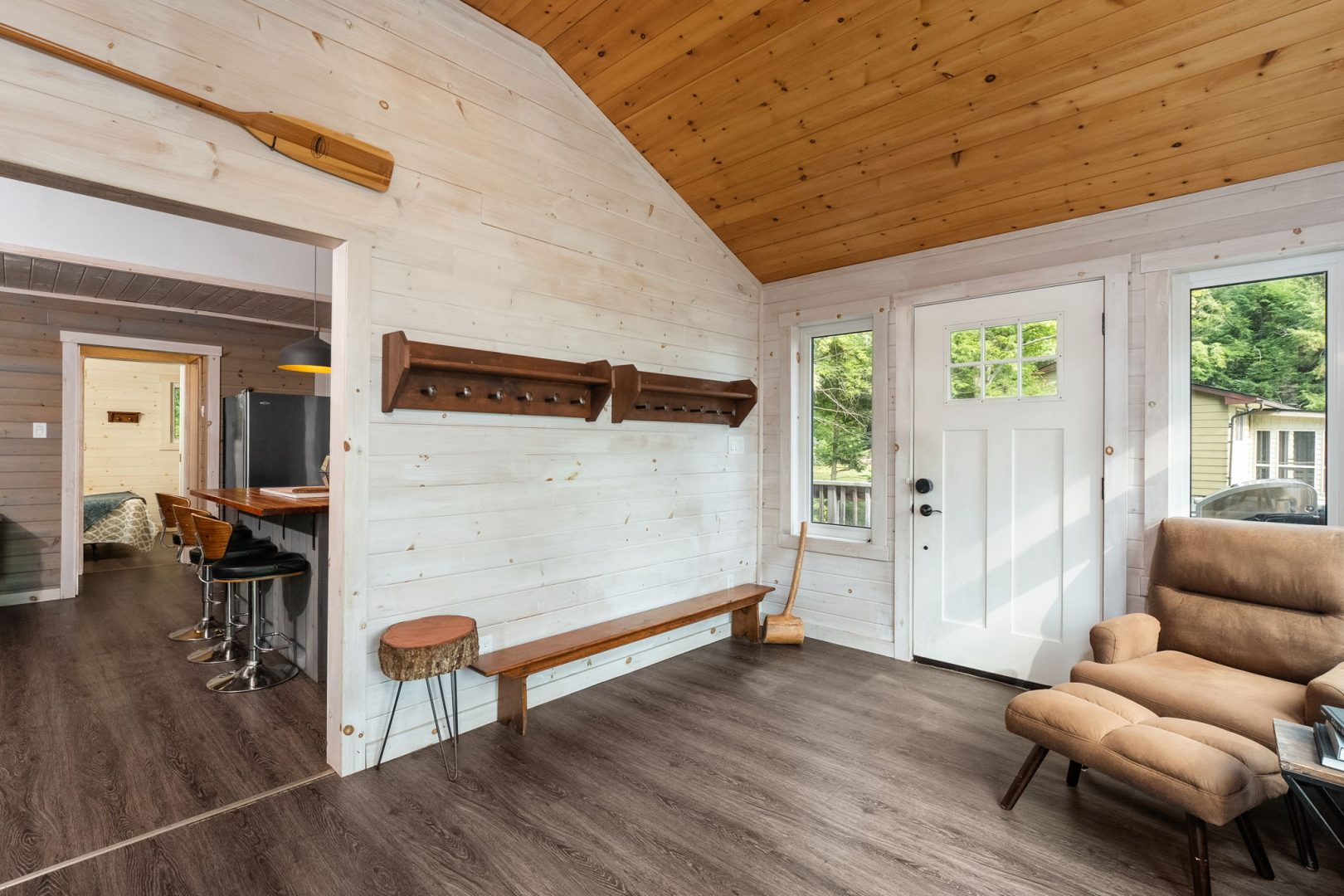 A white entryway with a wood ceiling