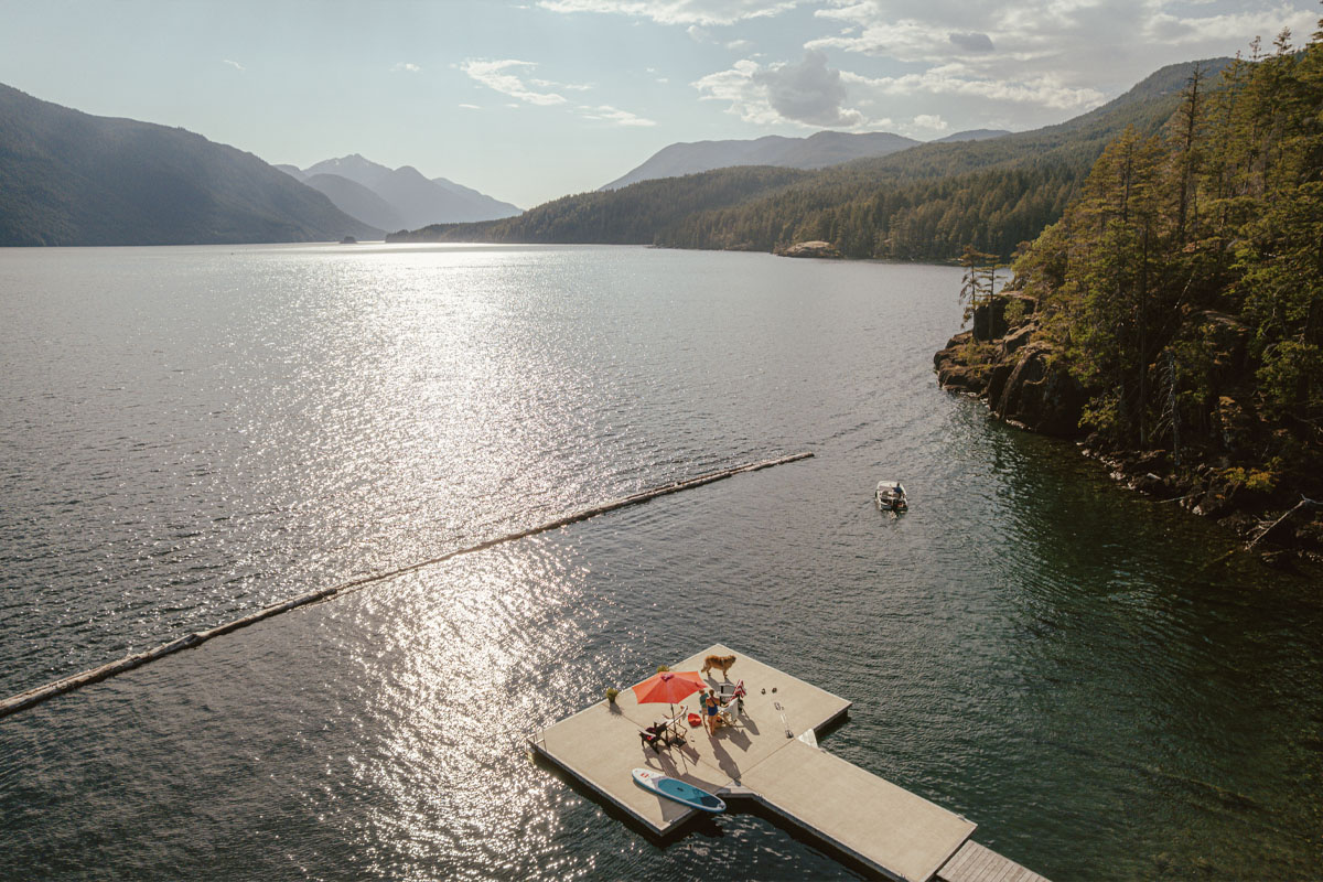 An aerial shot of the family from above while they are on their dock with Sproat Lake surrounding it