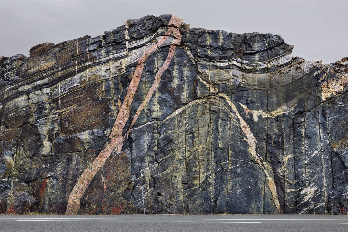 a rock cut of the Canadian shield along the highway