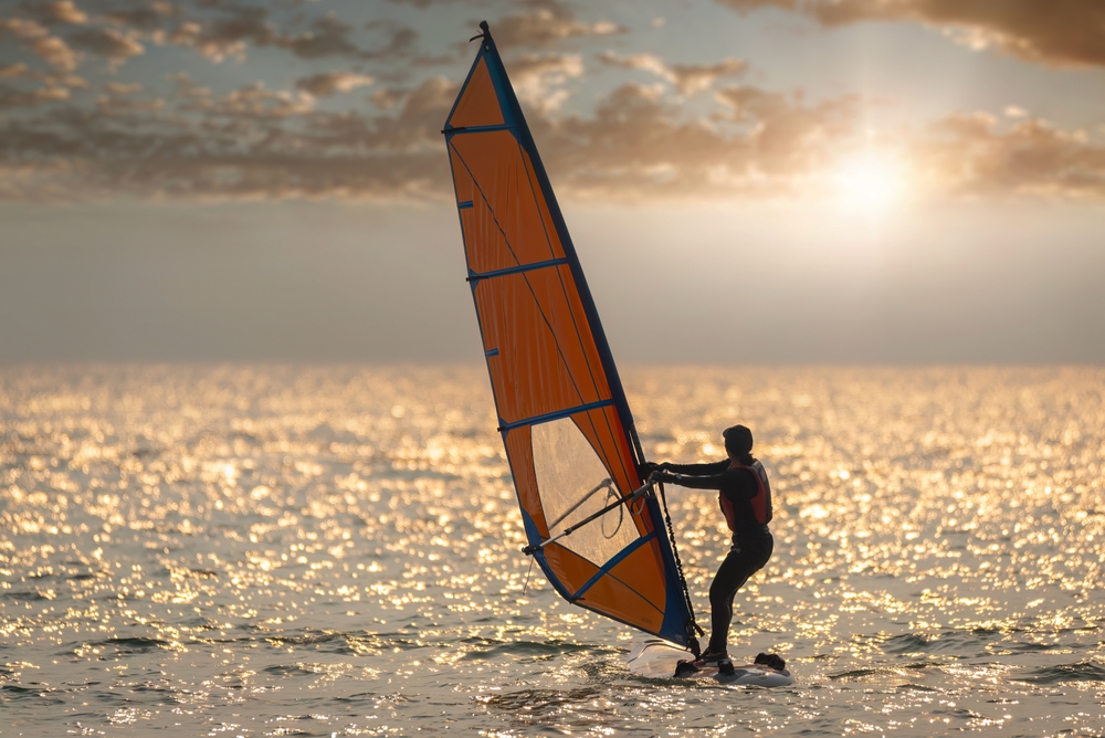 A windsurfer in silhouette