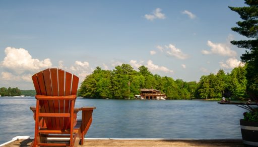 A single Muskoka chair on a dock
