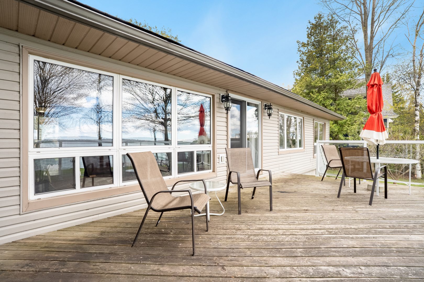 Two beige lawn chairs on a deck
