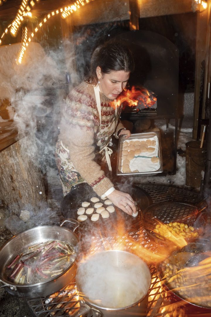 Christine Flynn cooking over a campfire