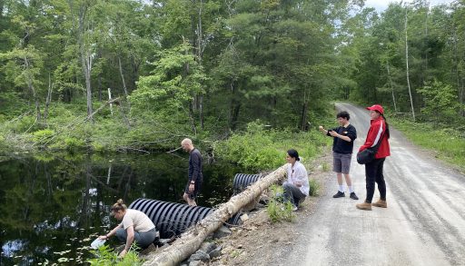 People taking water samples from a lake