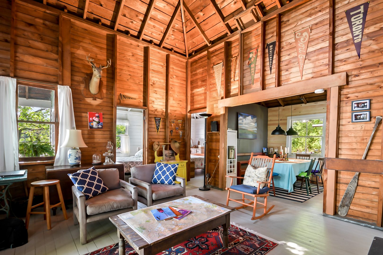 Eclectic furniture in a wood-paneled living room
