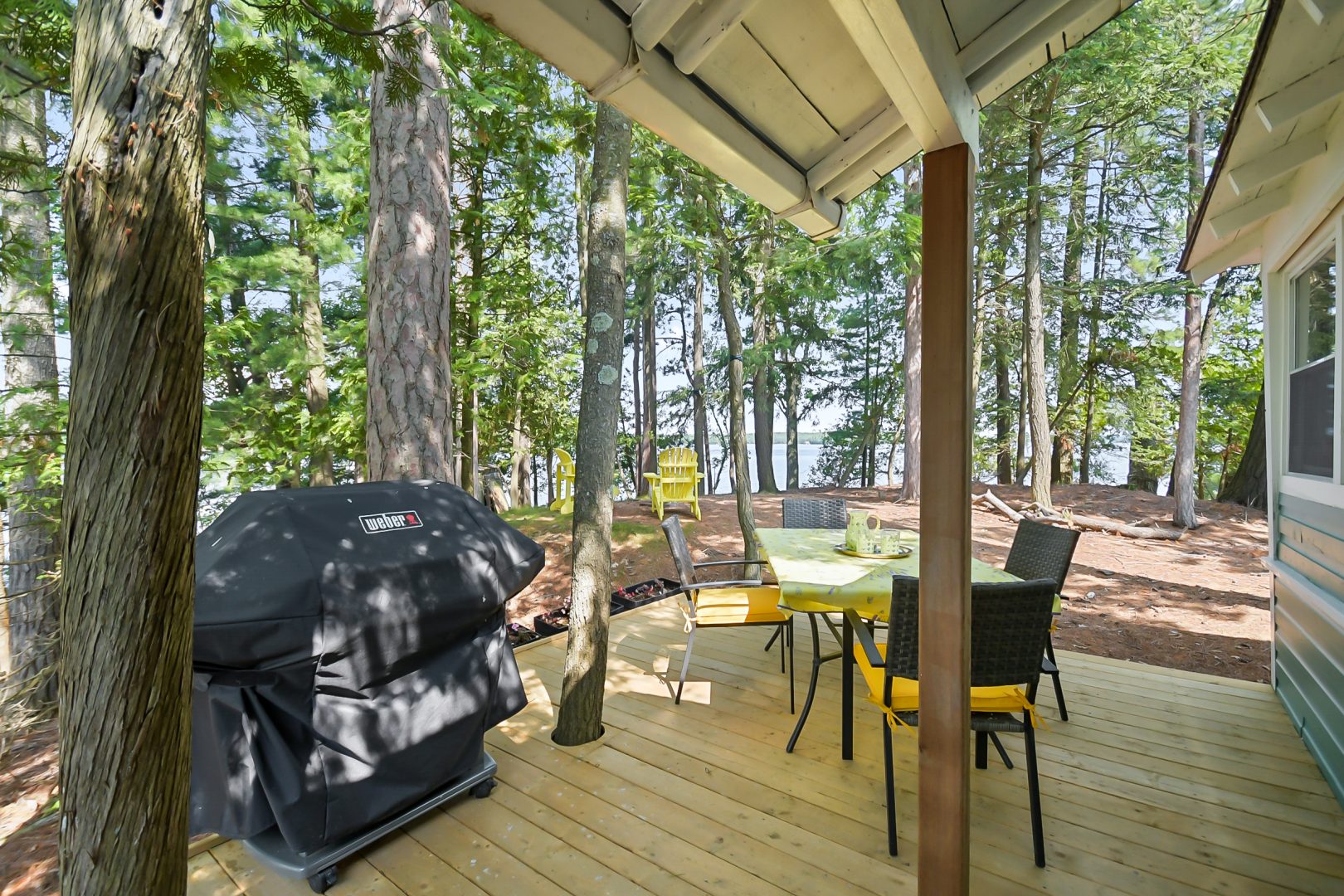 A small patio set next to a covered barbecue