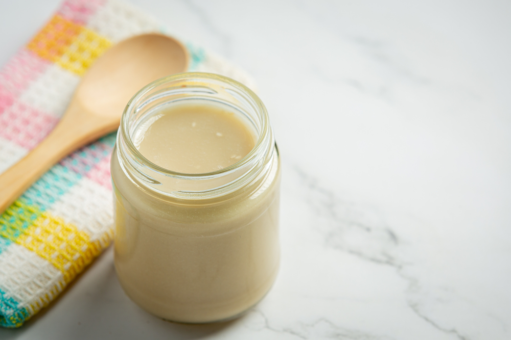 tahini and sesame seeds on marble background