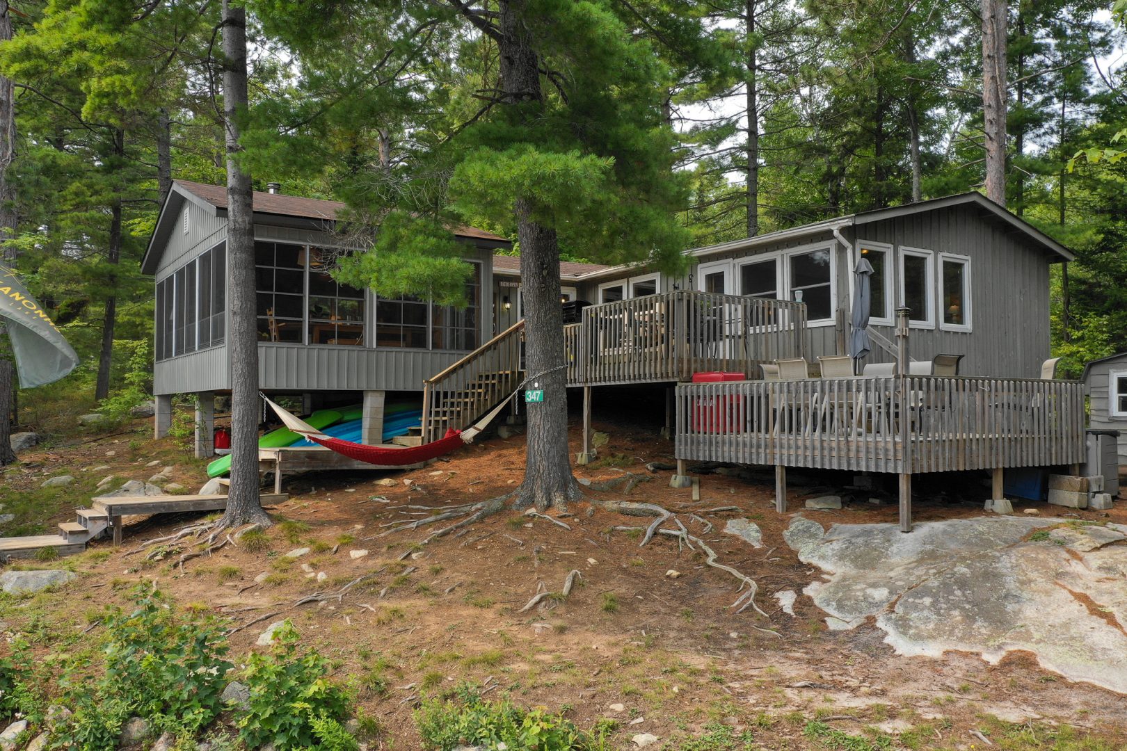 Multi-level decks at the back of a grey cottage