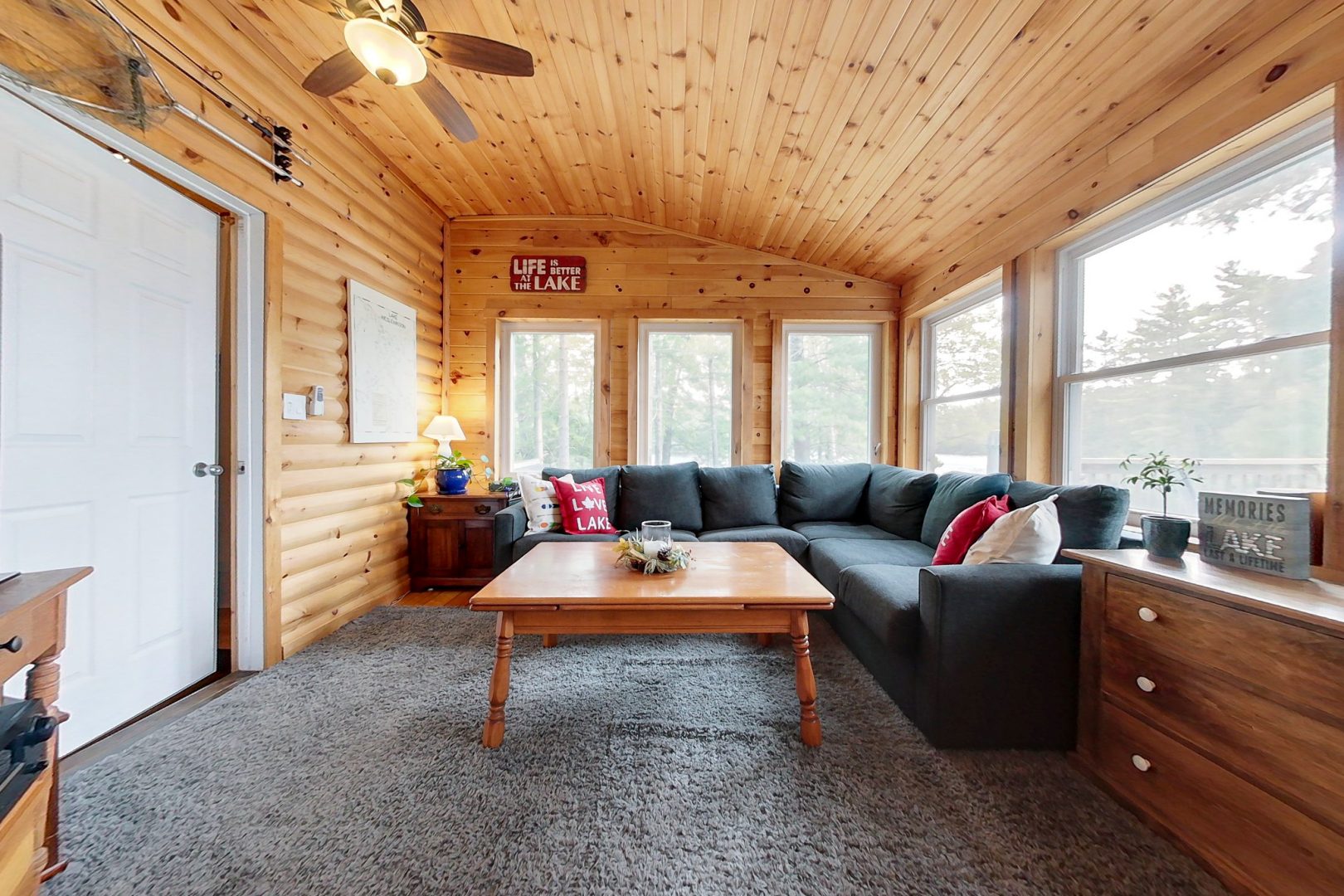 An L-shaped couch in a wood-paneled room