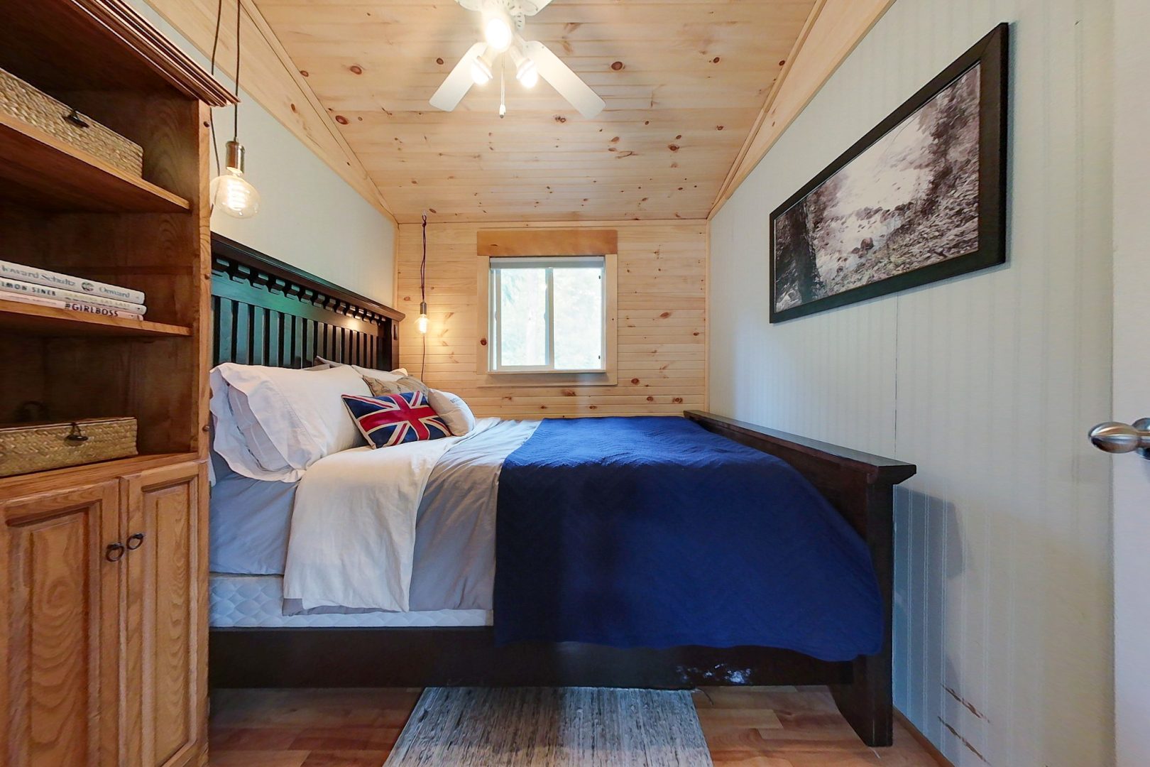 A blue bed in a small cottage bedroom