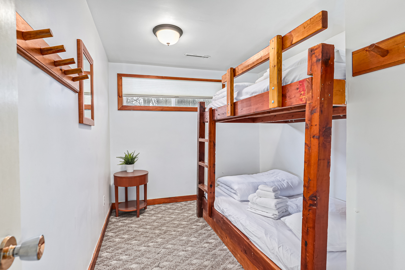 Wood bunk beds built into a white bedroom