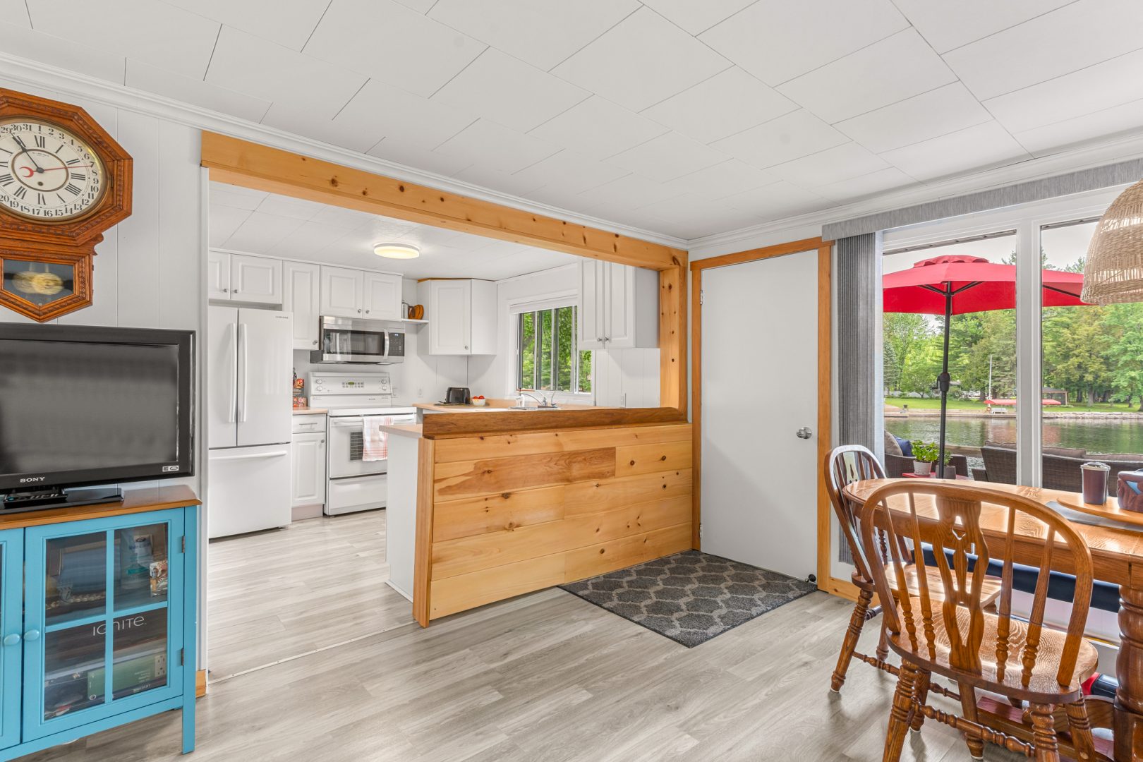A white kitchen with a wood high-top counter