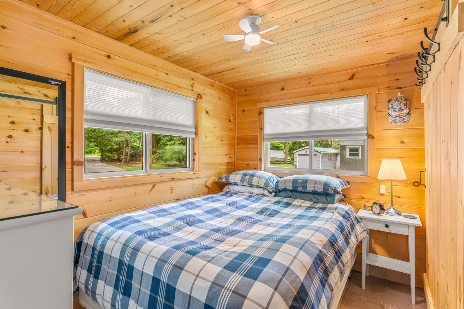 A plaid bed in a light wood bedroom