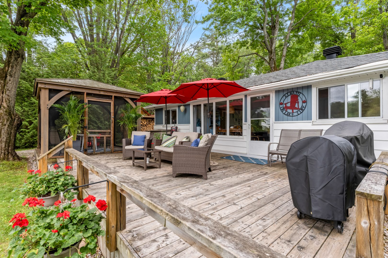 A deck with beige outdoor seating and a screened-in porch